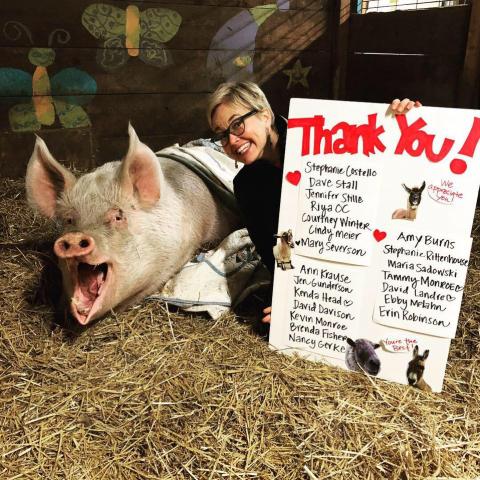Jen Korz with pig and thank you poster
